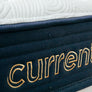 Current Mattress - Up close shot of Current logo stitched into mattress side